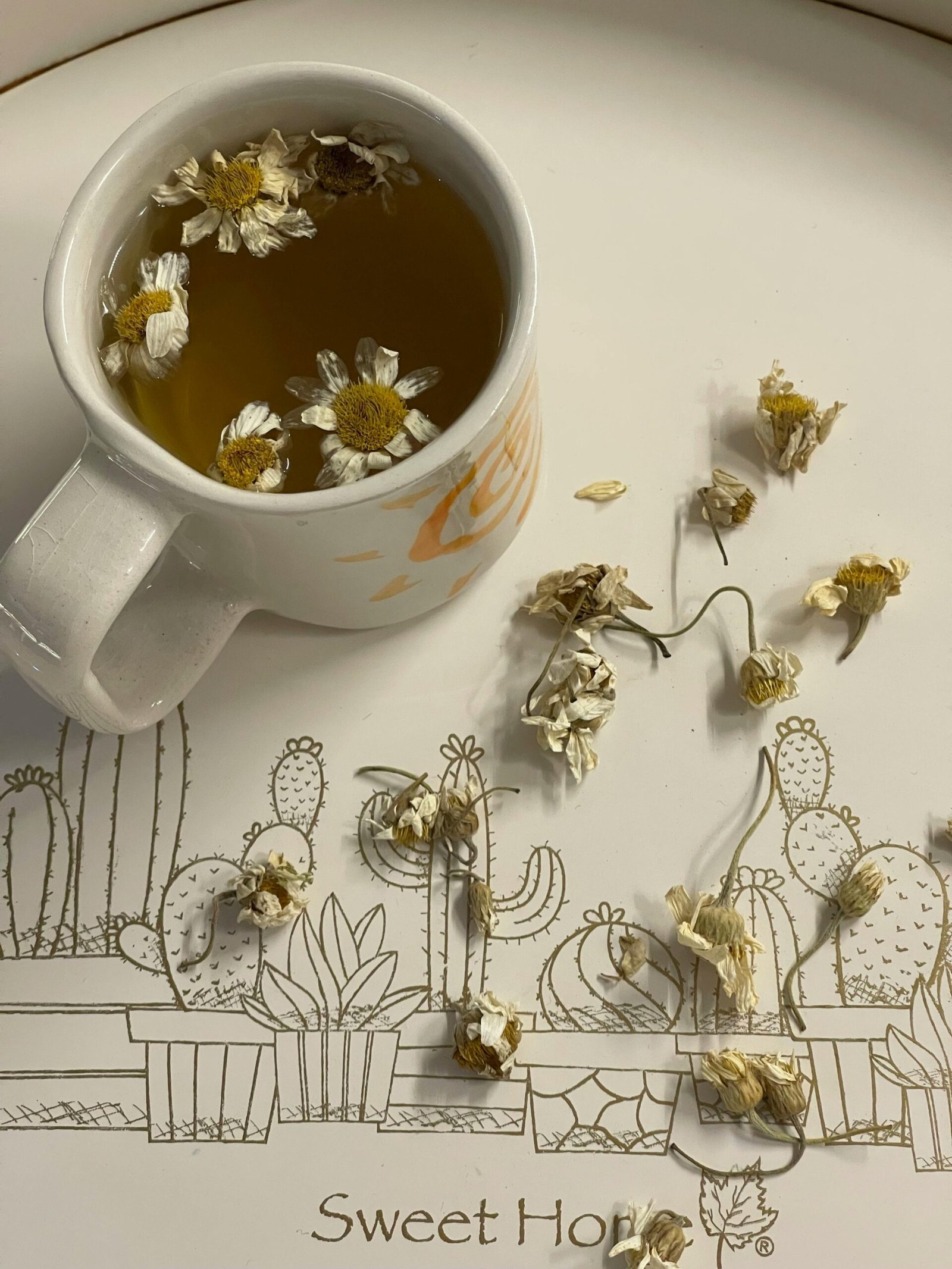 Cup of chamomile tea with chamomile flowers