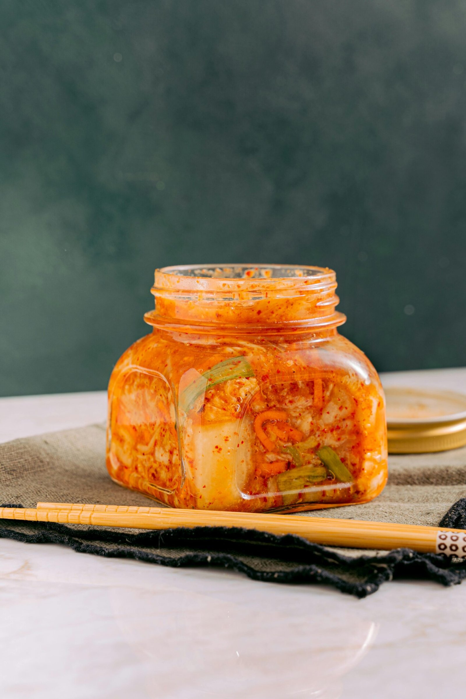 ar of kimchi (fermented vegetables) on a table.